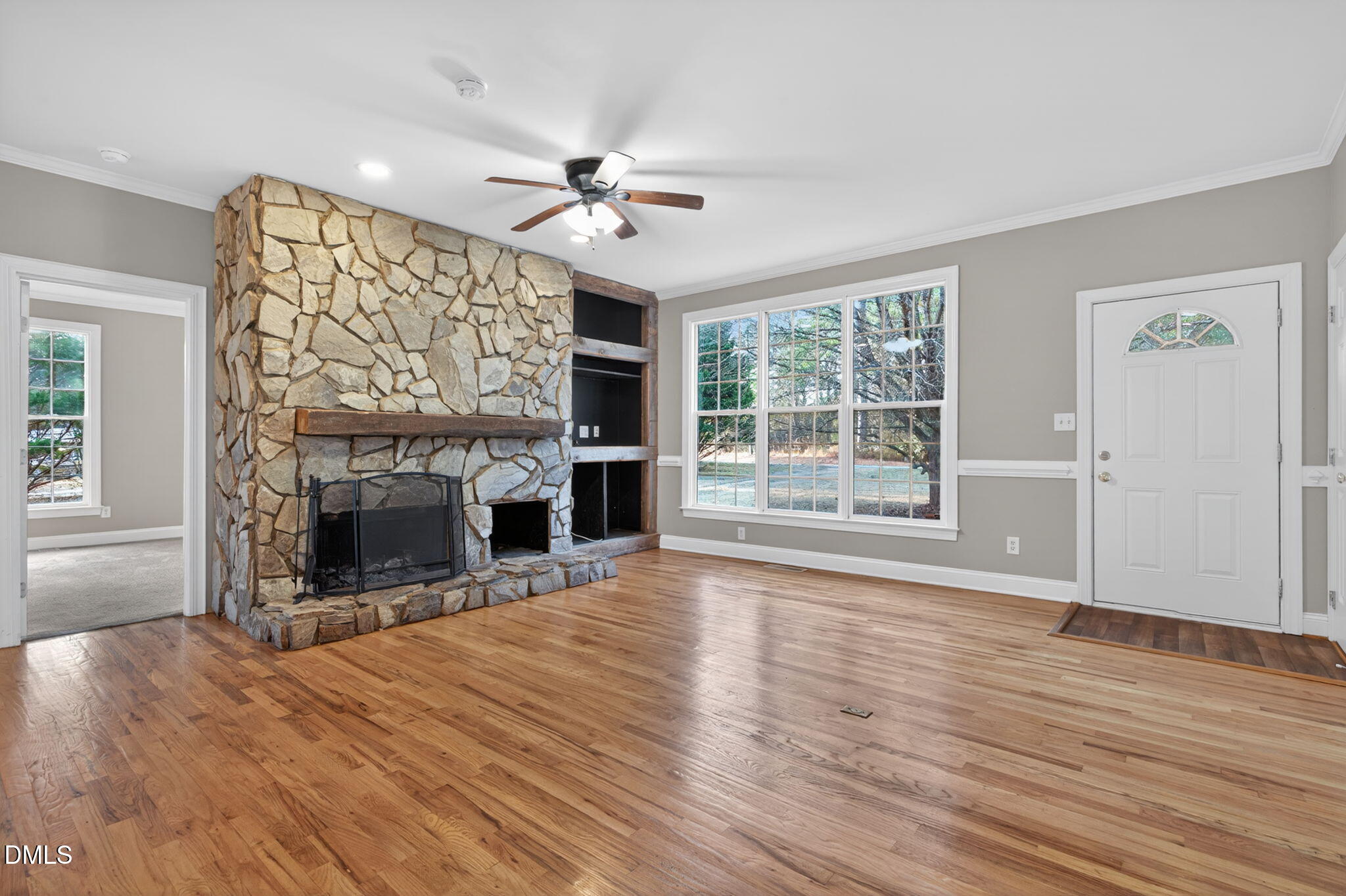 10000 Kennebec Road Willow Spring, NC 27592 - Photo 6 of 38 a view of an empty room with wooden floor fireplace and a window