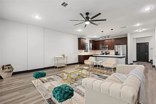 a living room with furniture and kitchen view