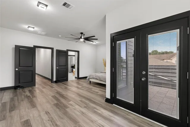 a view of a hallway with wooden floor and a living room