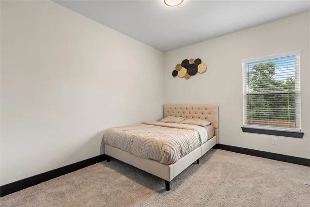 a spacious bedroom with a bed and a window