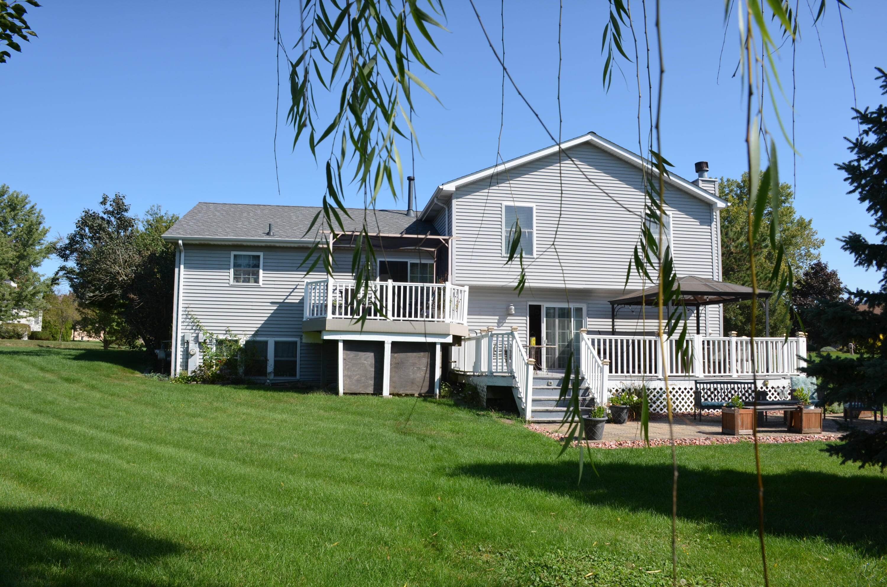 a front view of house with yard and green space