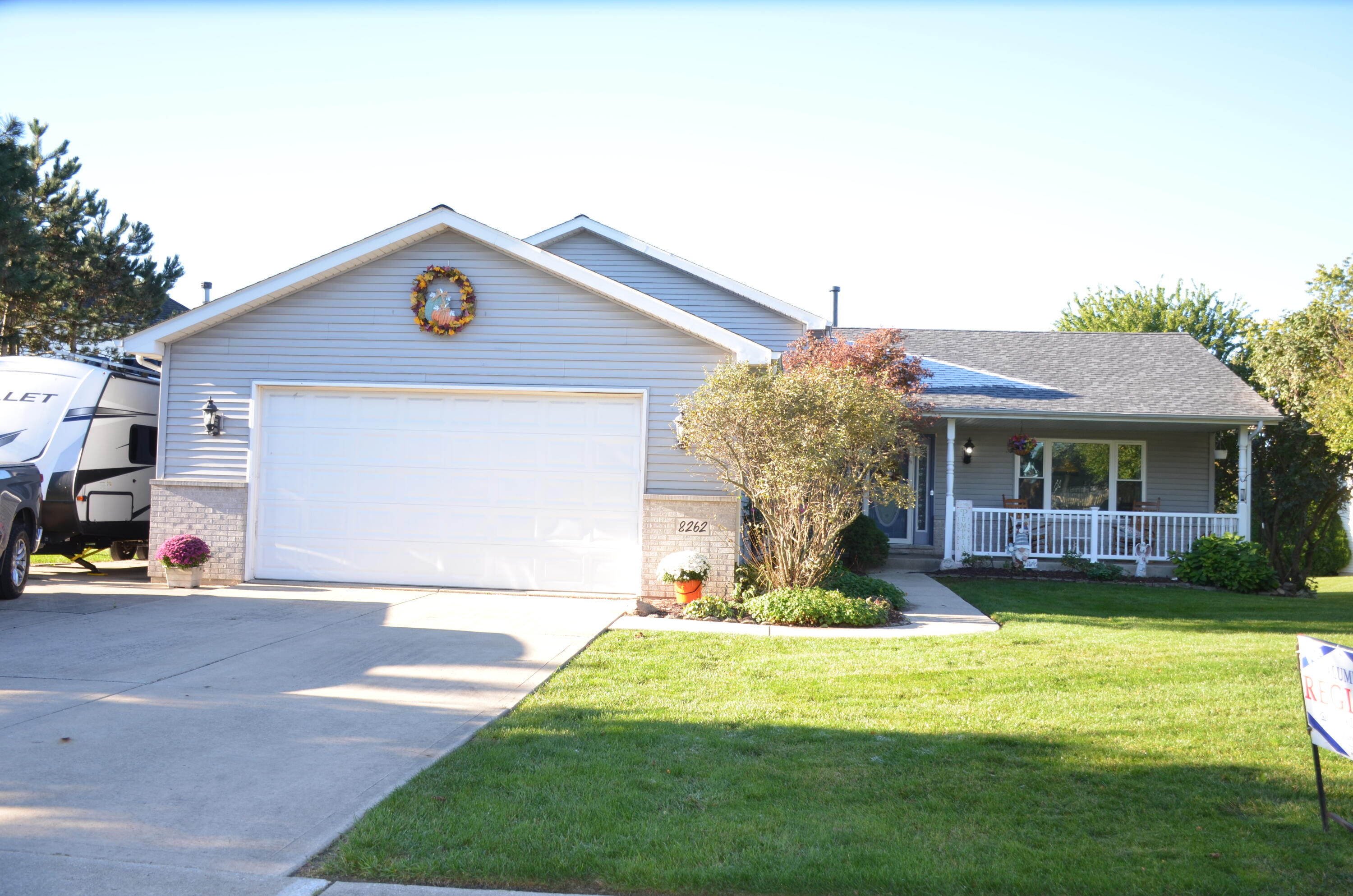 8262 Heron Lake Road St. John, IN 46373 - Photo 26 of 51 a front view of a house with a yard table and chairs
