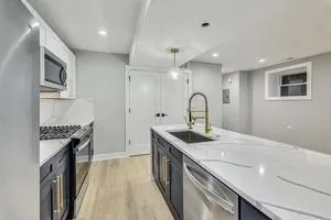 a kitchen with a sink stove and cabinets