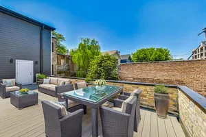 a view of house with outdoor seating and wooden floor