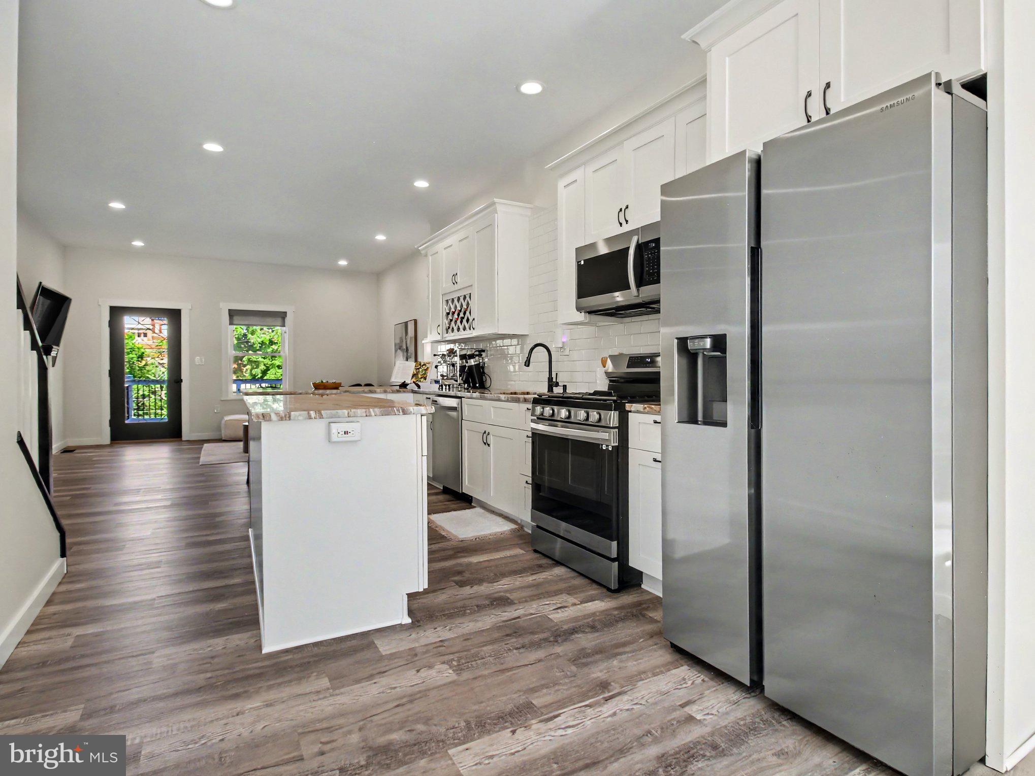 3915 Roland Avenue Baltimore, MD 21211 - Photo 2 of 26 a kitchen with stainless steel appliances a refrigerator sink and stove