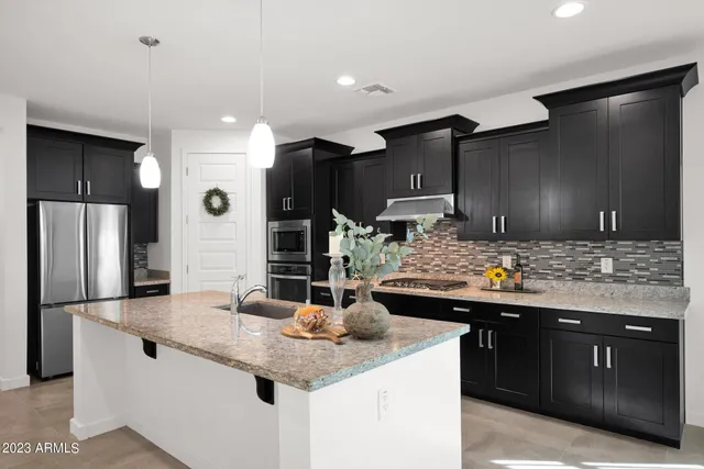 a kitchen with a sink and refrigerator