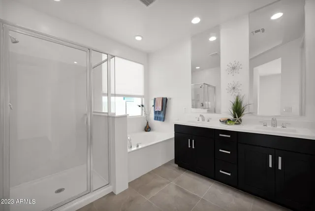 a spacious bathroom with a shower sink and mirror