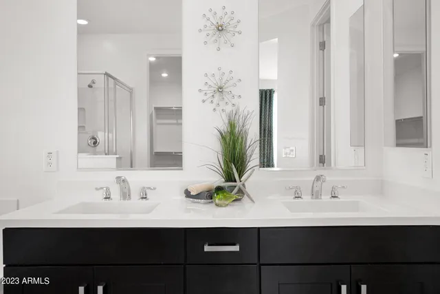 a bathroom with a sink double vanity and a mirror