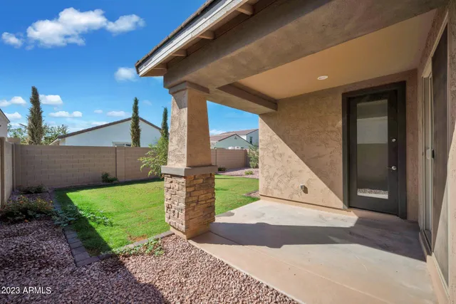 a view of a house with a backyard