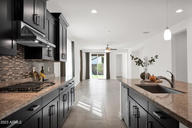 a kitchen with sink a stove and cabinets
