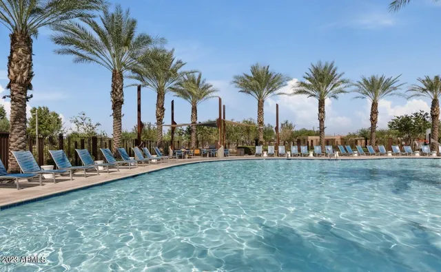 a living room with furniture a fireplace and a large window