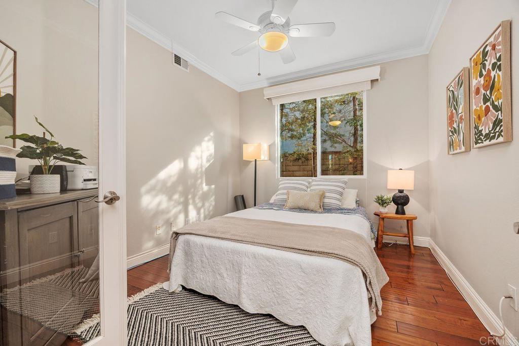 6707 Blue Point Drive Carlsbad, CA 92011 - Photo 21 of 43 a bedroom with a bed and a chandelier