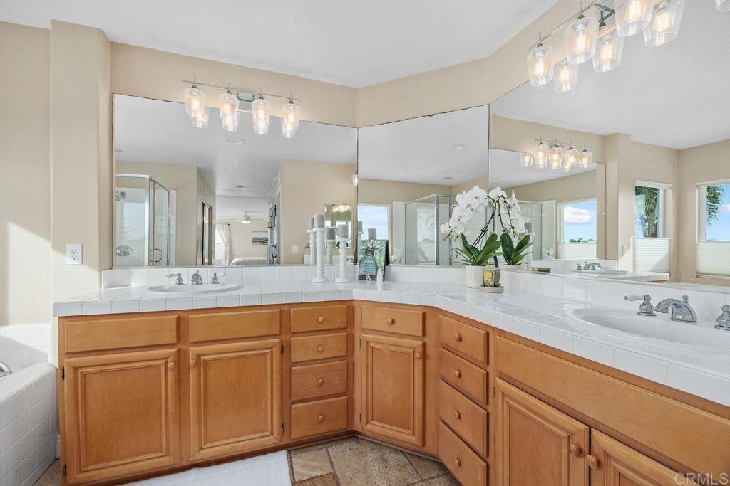 6707 Blue Point Drive Carlsbad, CA 92011 - Photo 31 of 43 a bathroom with double vanity and a mirror