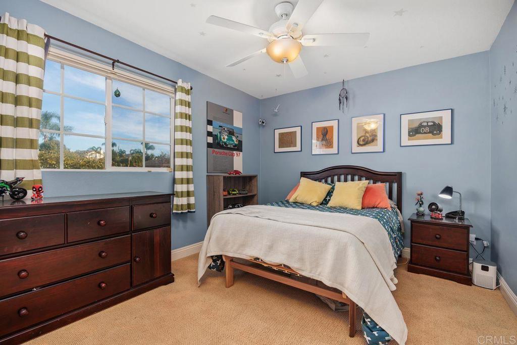 6707 Blue Point Drive Carlsbad, CA 92011 - Photo 34 of 43 a bedroom with a bed and a chandelier