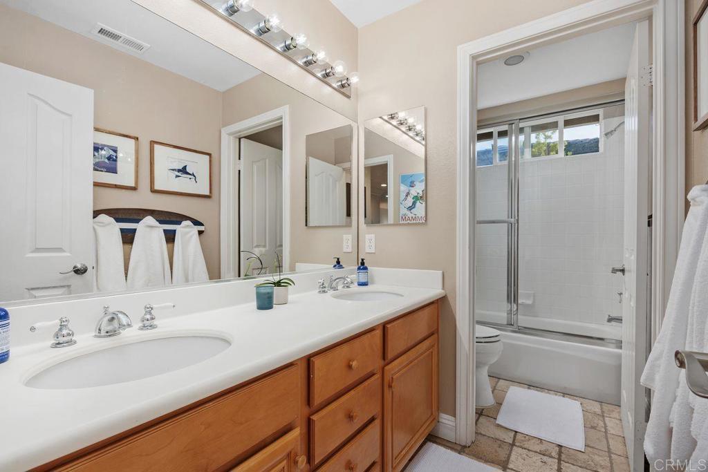 6707 Blue Point Drive Carlsbad, CA 92011 - Photo 35 of 43 a bathroom with a double vanity sink mirror and