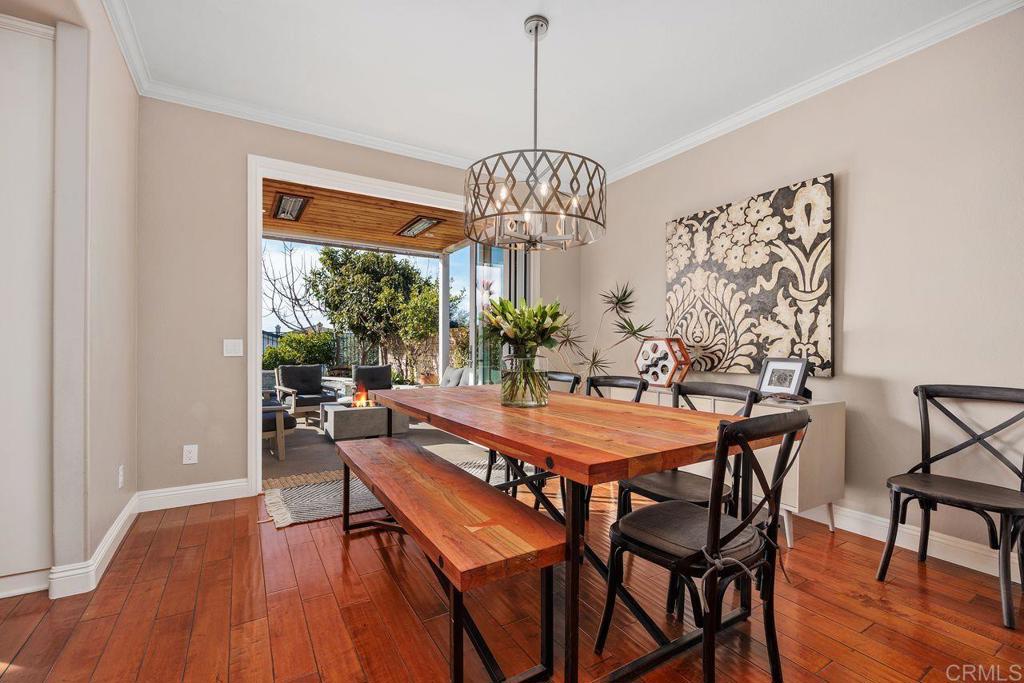 6707 Blue Point Drive Carlsbad, CA 92011 - Photo 5 of 43 a dining room with furniture a chandelier and wooden floor