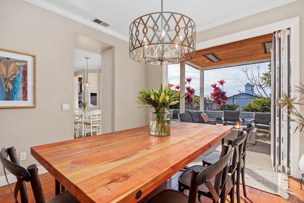 6707 Blue Point Drive Carlsbad, CA 92011 - Photo 6 of 43 a dining room filled chandelier and wooden furniture