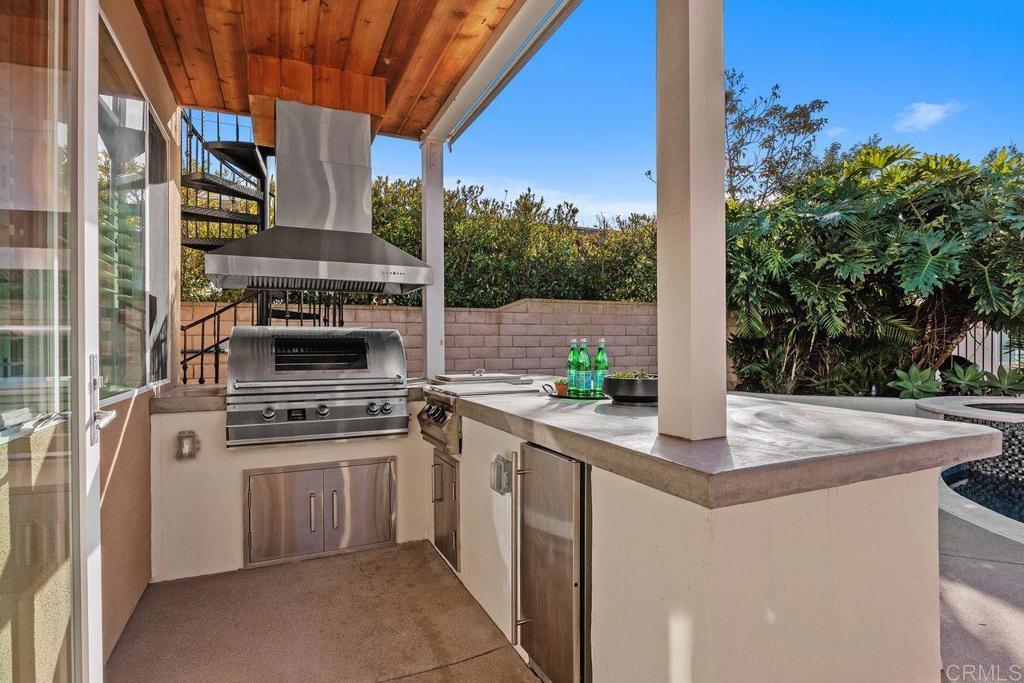 6707 Blue Point Drive Carlsbad, CA 92011 - Photo 9 of 43 a kitchen with stainless steel appliances granite countertop a stove a sink and a refrigerator