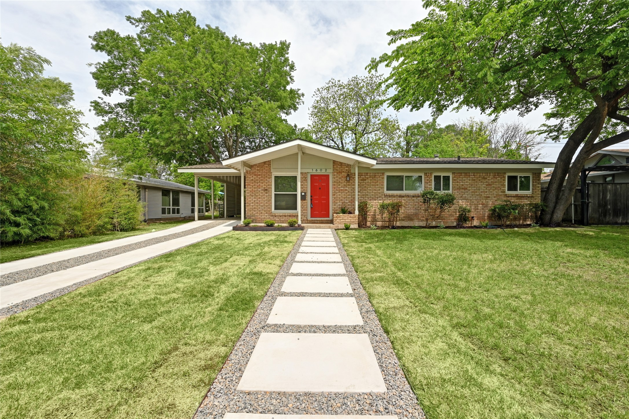 1602 Chatham Avenue Austin, TX 78723 - Photo 1 of 1 View of front of house with brick siding and a front lawn