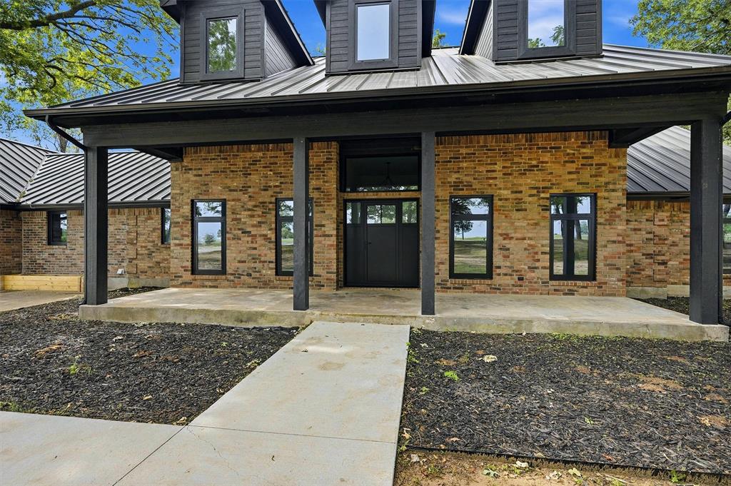 410 Arkansas Road Sadler, TX 76264 - Photo 3 of 40 a front view of a house with garden