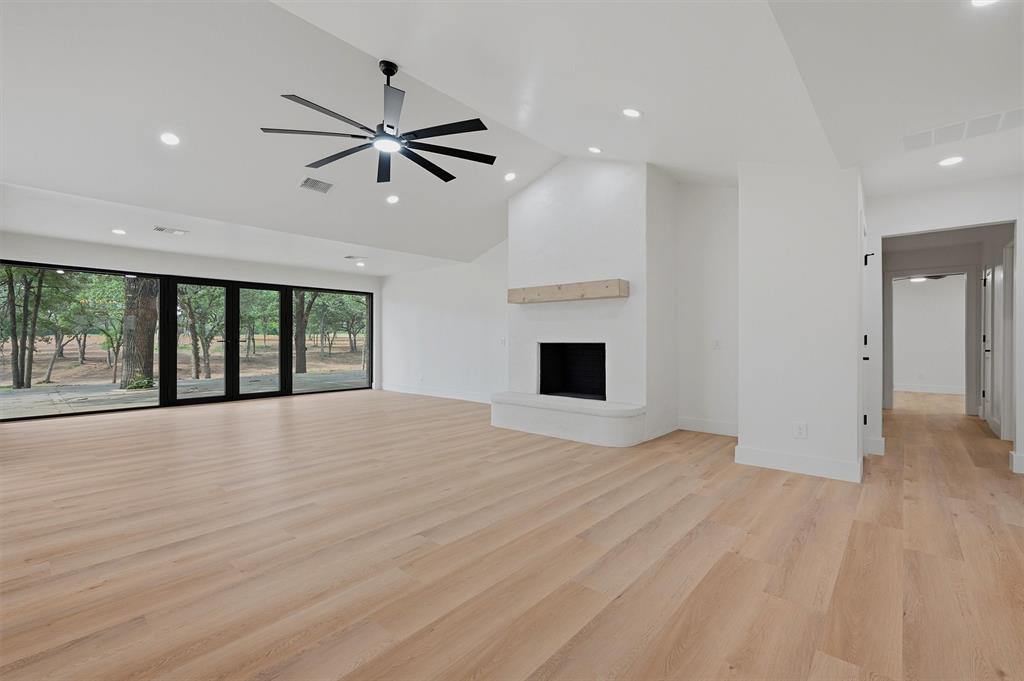 410 Arkansas Road Sadler, TX 76264 - Photo 10 of 40 a view of an empty room with a window and wooden floor