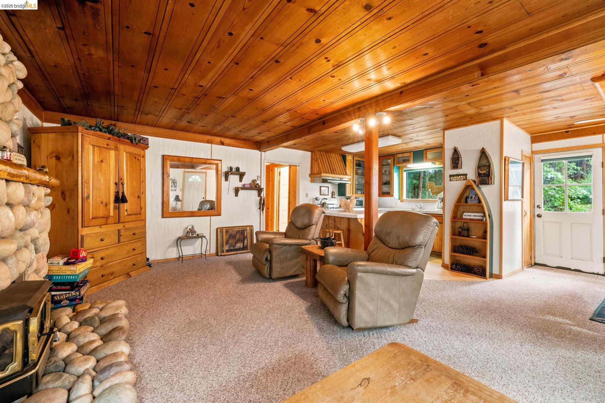 25822 Long Barn Sugar Pine Road Long Barn, CA 95335 - Photo 7 of 28 a living room with furniture a lamp wooden floor and a potted plant