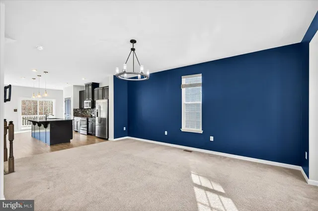 a view of a kitchen with furniture and wooden floor
