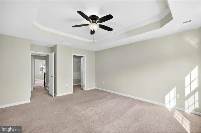 a view of an empty room with a ceiling fan