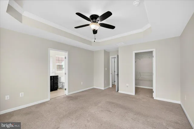 a view of an empty room with a ceiling fan