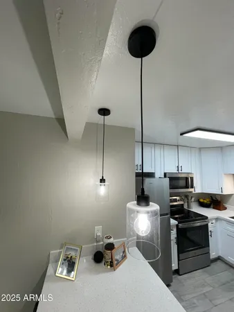 a white refrigerator freezer and a stove sitting inside of a kitchen