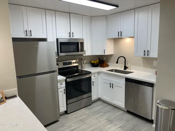 a stove top oven sitting inside of a kitchen