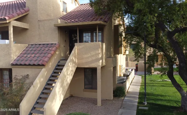 a view of a chairs and table in a balcony