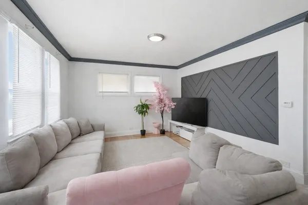 a living room with furniture and a flat screen tv