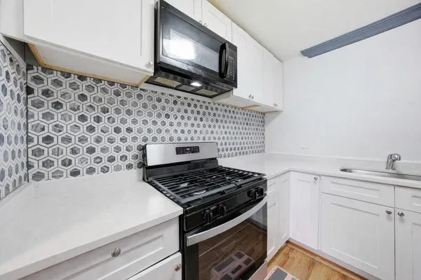 a kitchen with a stove and a microwave