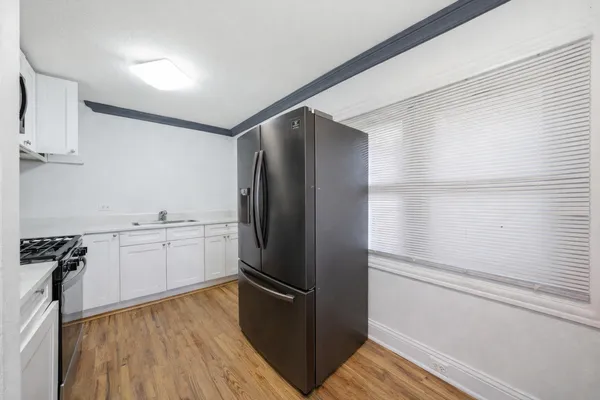 a kitchen with a refrigerator and a sink