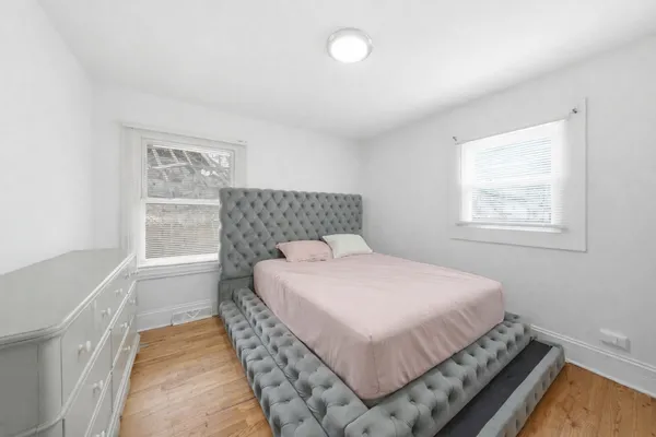 a bedroom with a bed and window