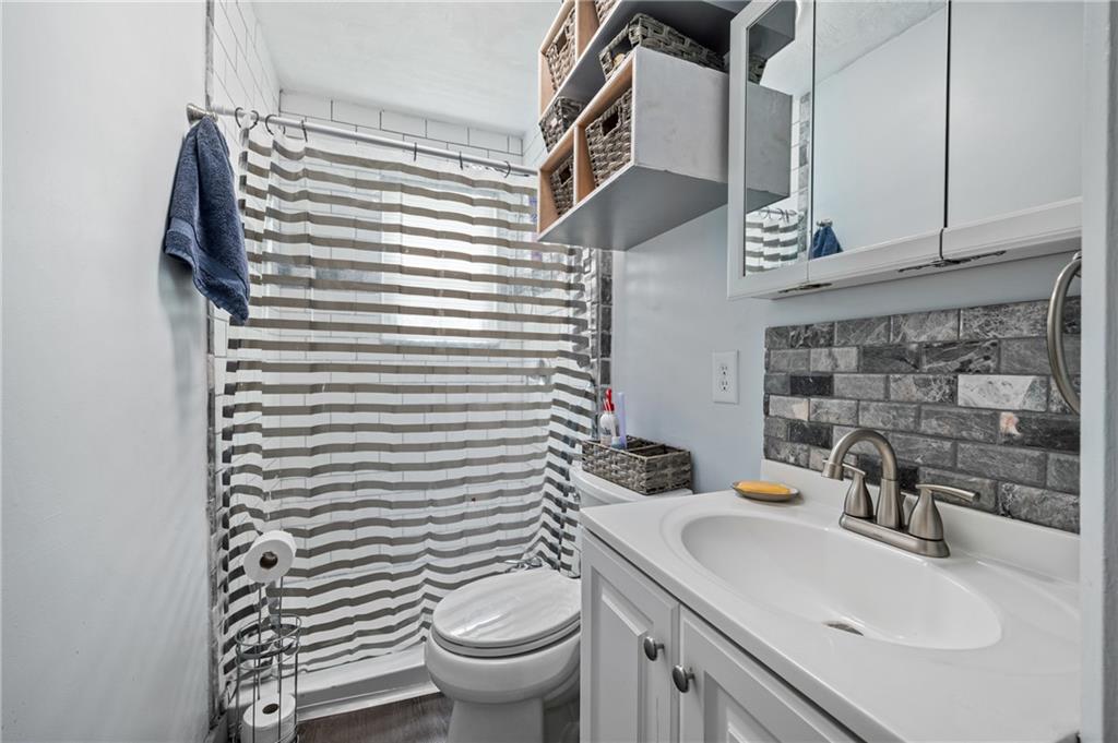 1241 Cochran Road Pittsburgh, PA 15243 - Photo 12 of 30 a bathroom with a sink a toilet and mirror