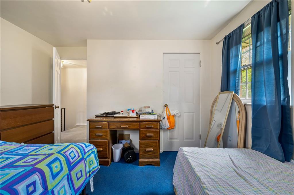 1241 Cochran Road Pittsburgh, PA 15243 - Photo 15 of 30 a bedroom with a bed and a chandelier