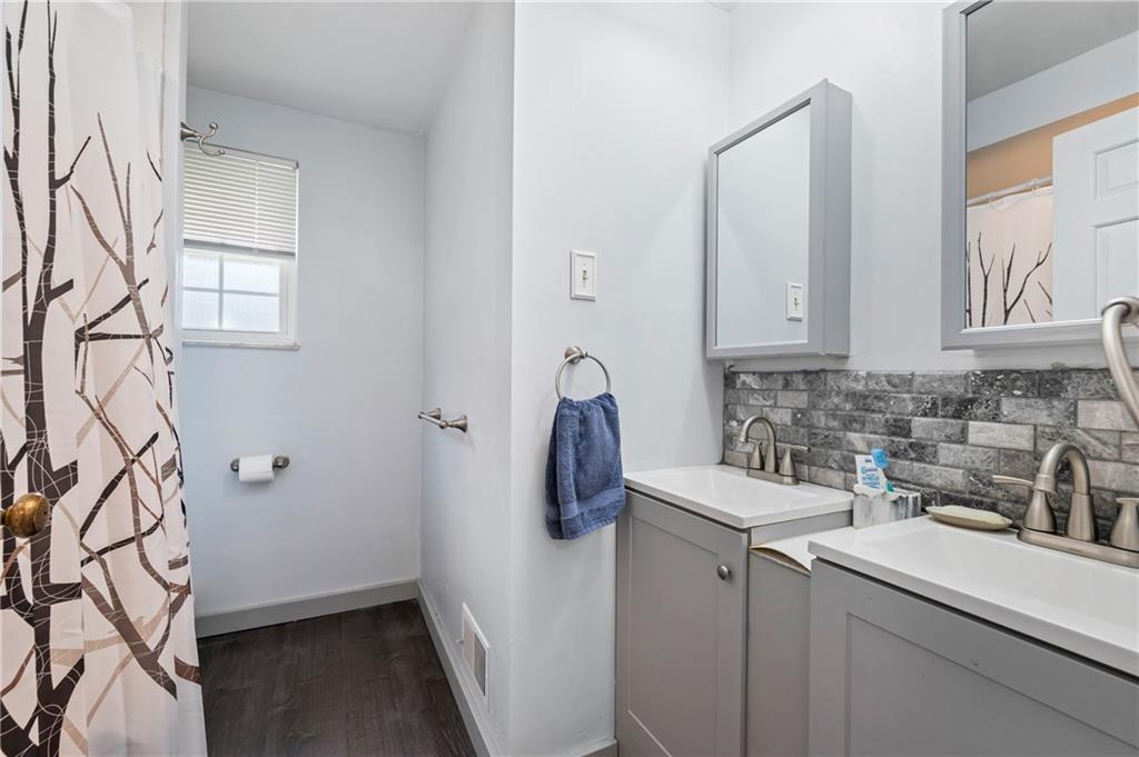 1241 Cochran Road Pittsburgh, PA 15243 - Photo 16 of 30 a bathroom with a sink and mirror with window