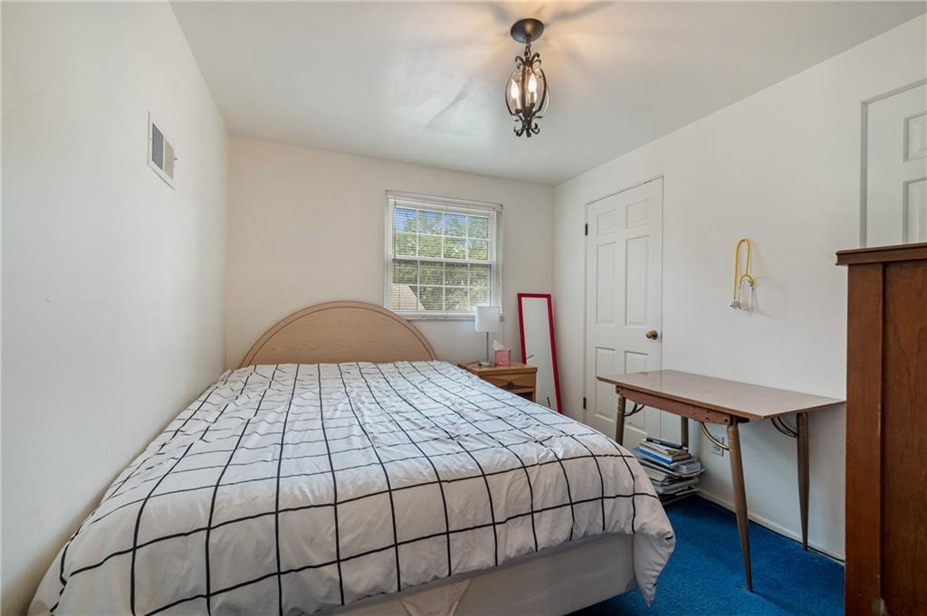 1241 Cochran Road Pittsburgh, PA 15243 - Photo 18 of 30 a bedroom with a bed and a table