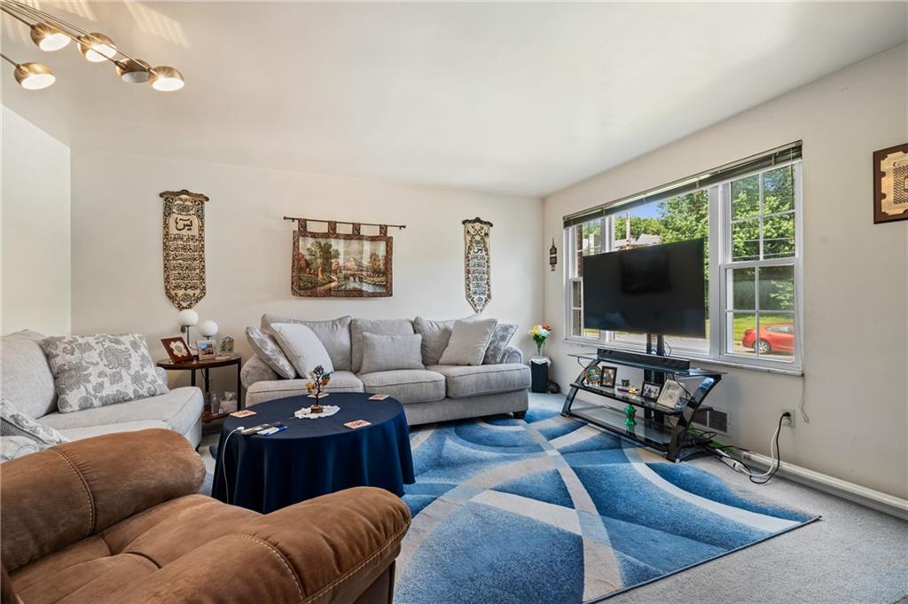 1241 Cochran Road Pittsburgh, PA 15243 - Photo 3 of 30 a living room with furniture and a flat screen tv