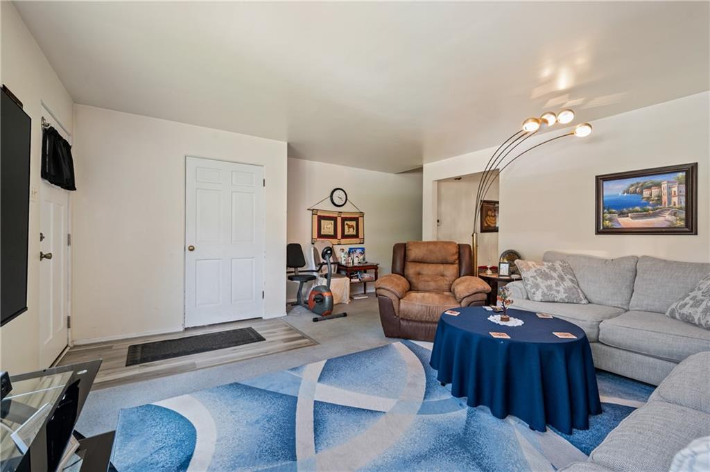 1241 Cochran Road Pittsburgh, PA 15243 - Photo 4 of 30 a living room with furniture and a flat screen tv