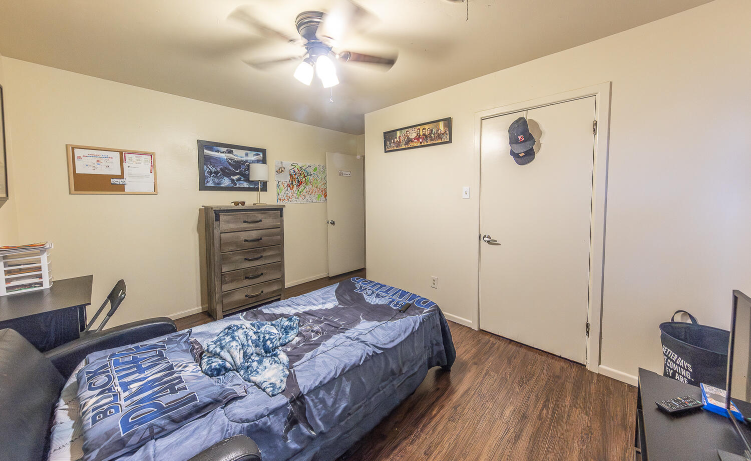 2412 33rd Street Lubbock, TX 79411 - Photo 12 of 34 a bedroom with a bed and a dresser