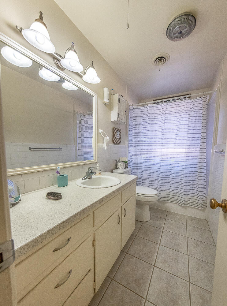 2412 33rd Street Lubbock, TX 79411 - Photo 13 of 34 a bathroom with a sink a toilet and shower