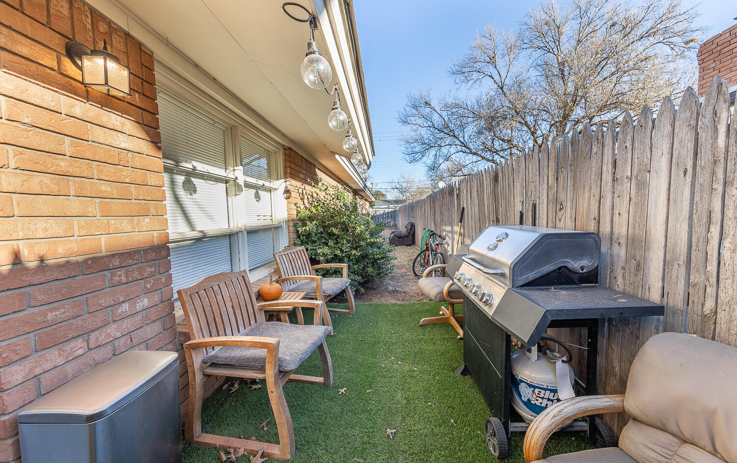 2412 33rd Street Lubbock, TX 79411 - Photo 15 of 34 a backyard of a house with table and chairs