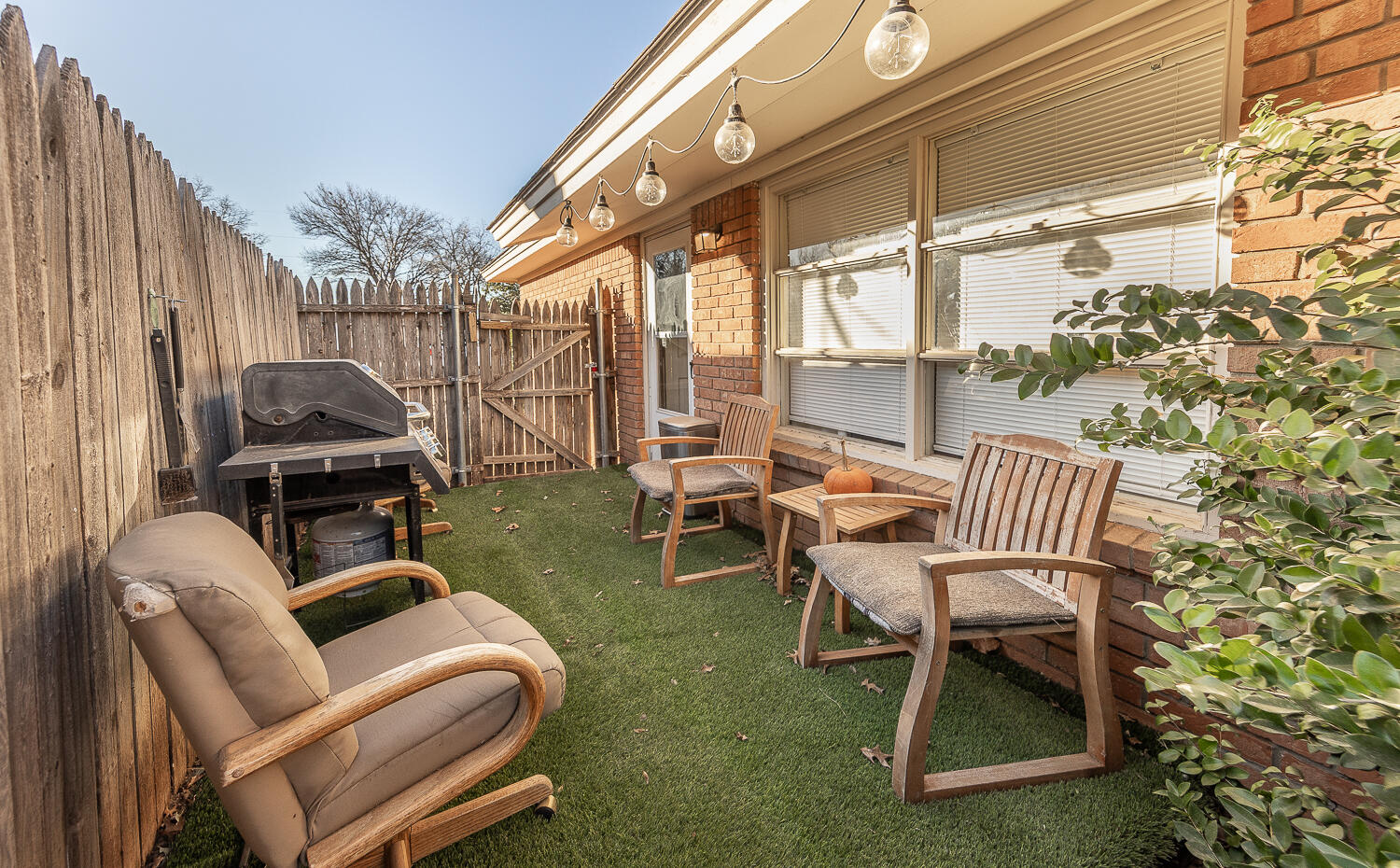 2412 33rd Street Lubbock, TX 79411 - Photo 16 of 34 a view of a patio with table and chairs with wooden floor and fence