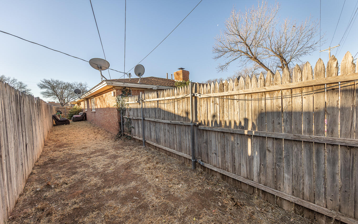 2412 33rd Street Lubbock, TX 79411 - Photo 17 of 34 a view of a backyard with wooden fence