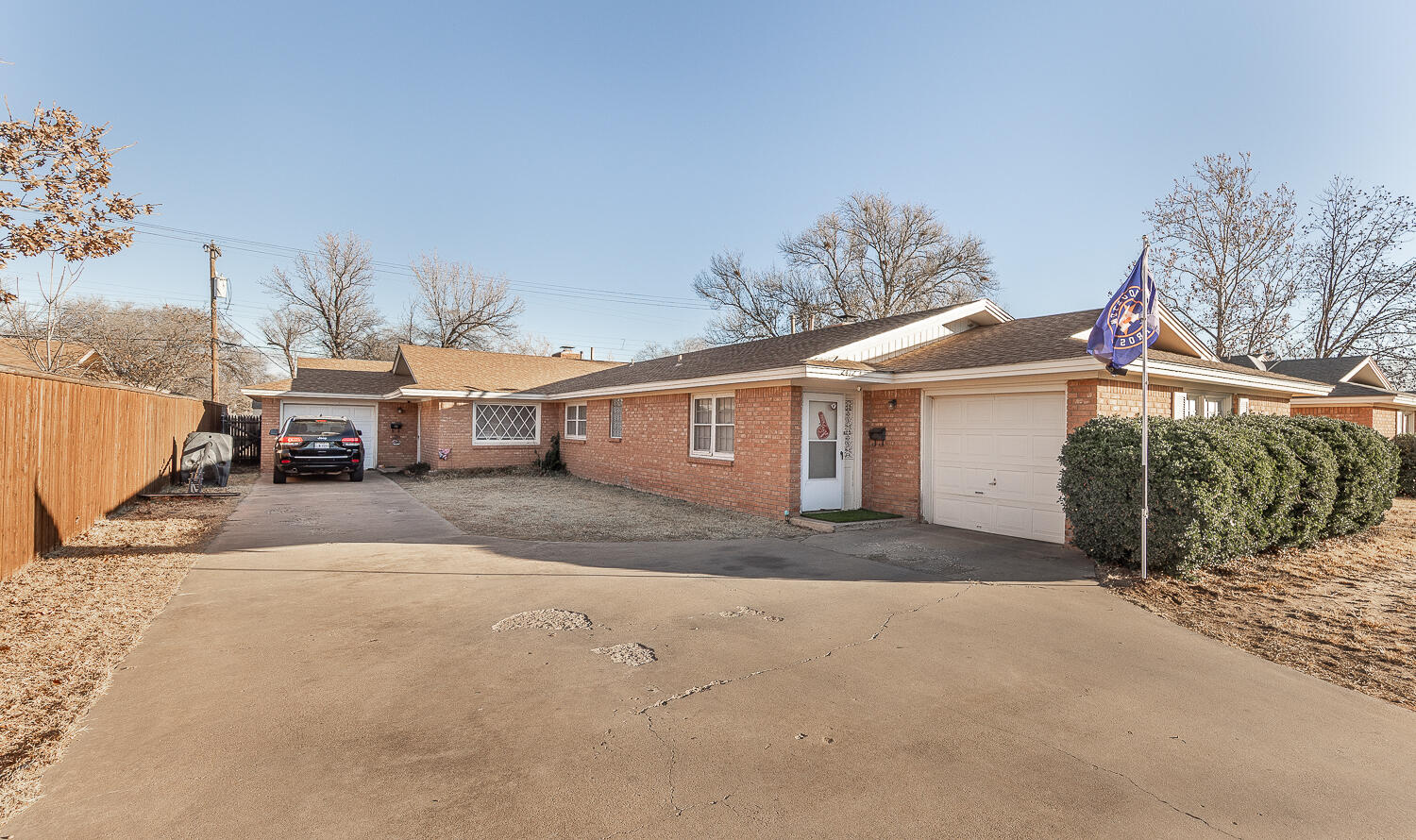2412 33rd Street Lubbock, TX 79411 - Photo 18 of 34 a view of a house with a yard and garage