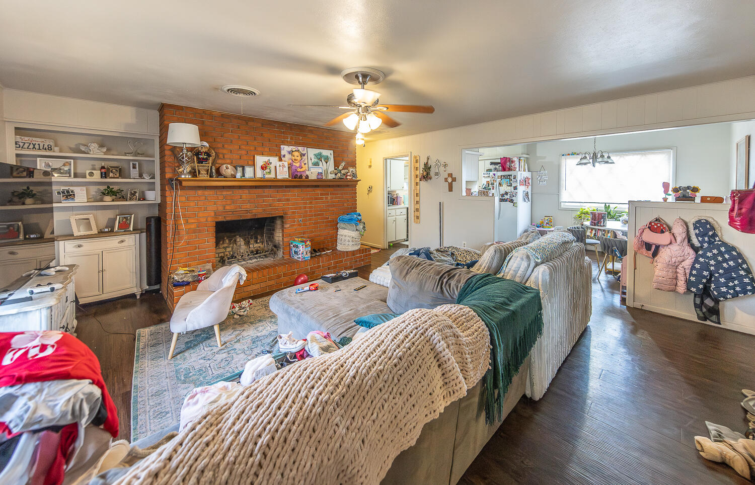2412 33rd Street Lubbock, TX 79411 - Photo 20 of 34 a living room with furniture a fireplace and a chandelier