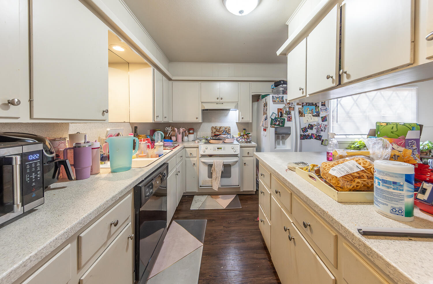2412 33rd Street Lubbock, TX 79411 - Photo 25 of 34 a kitchen filled with white cabinets and white appliances